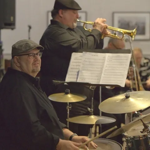 RJ Spangler playing drums and band mate playing trumpet