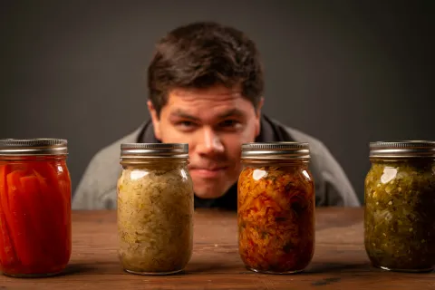 Guy looking at preserved food.