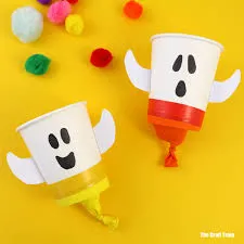 2 examples of the ghost popper craft with pompoms above them