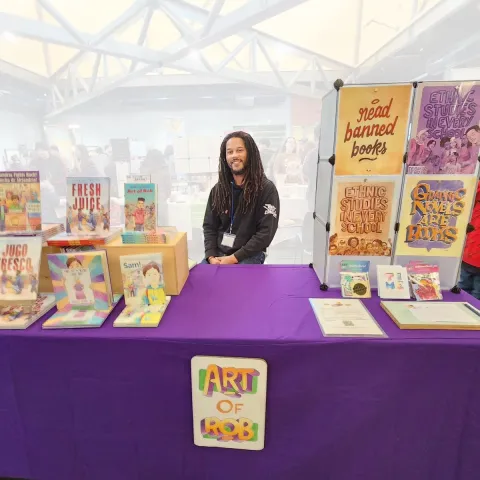 Robert vending his books and merch. 