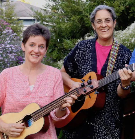 Photo of person holding ukulele and person holding guitar
