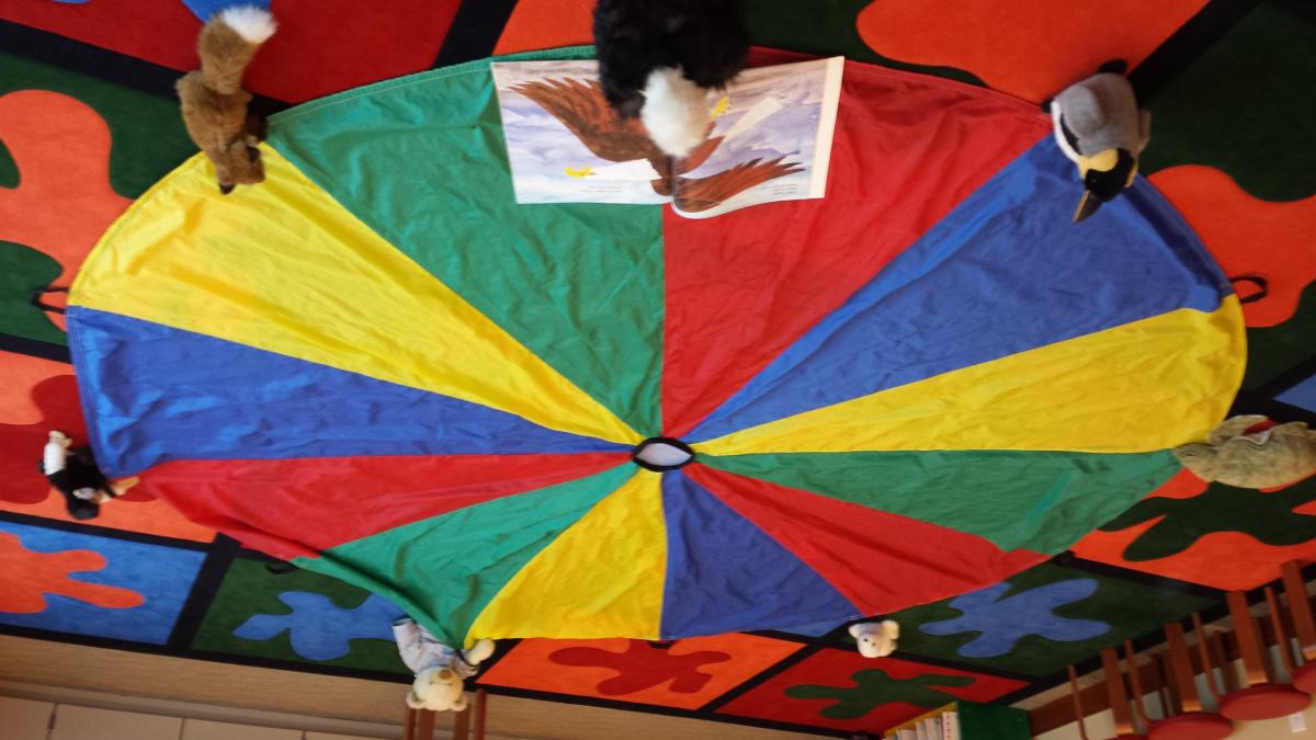 kids playing with a colorful parachute 