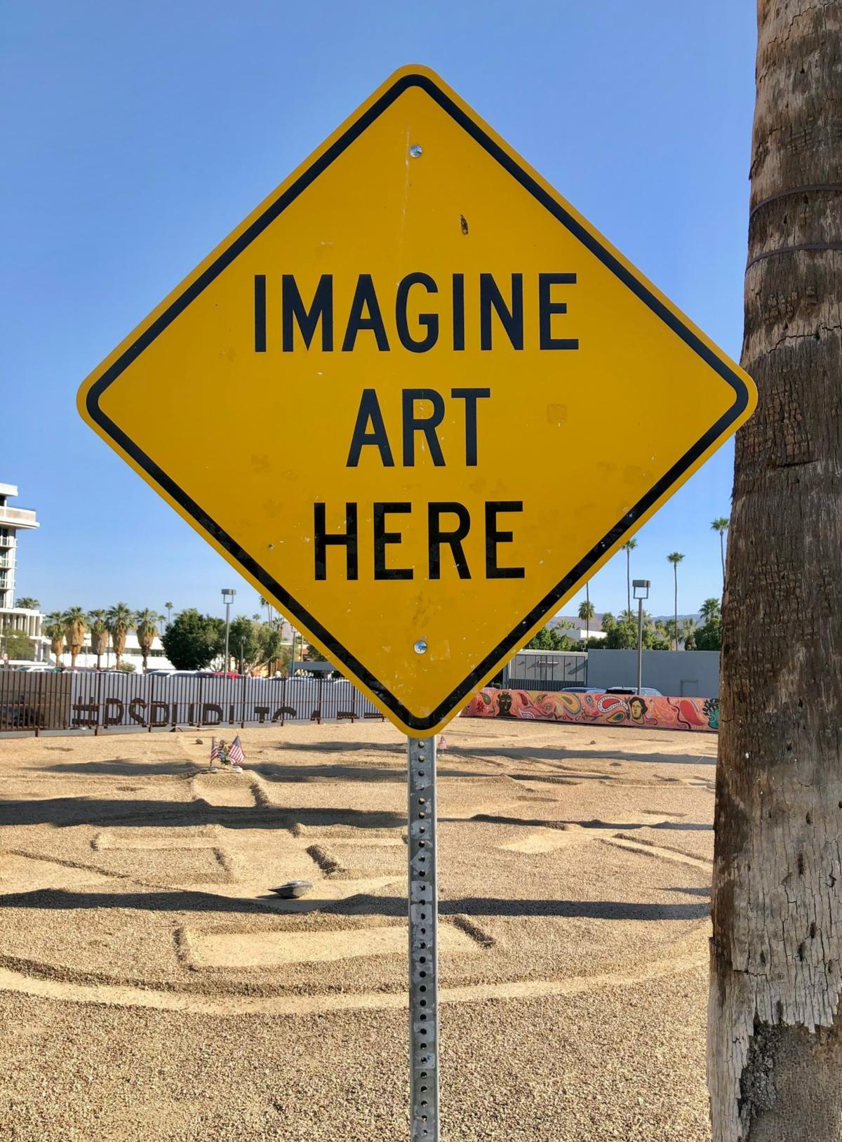 Diamond shaped yellow sign says "Imagine Art Here"