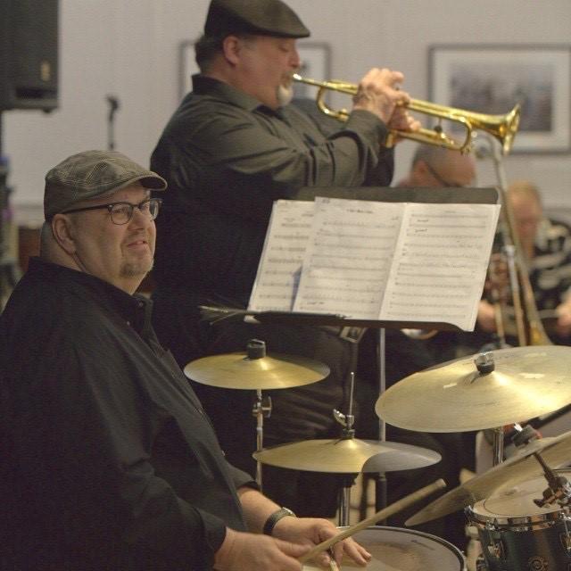 RJ Spangler playing drums and band mate playing trumpet